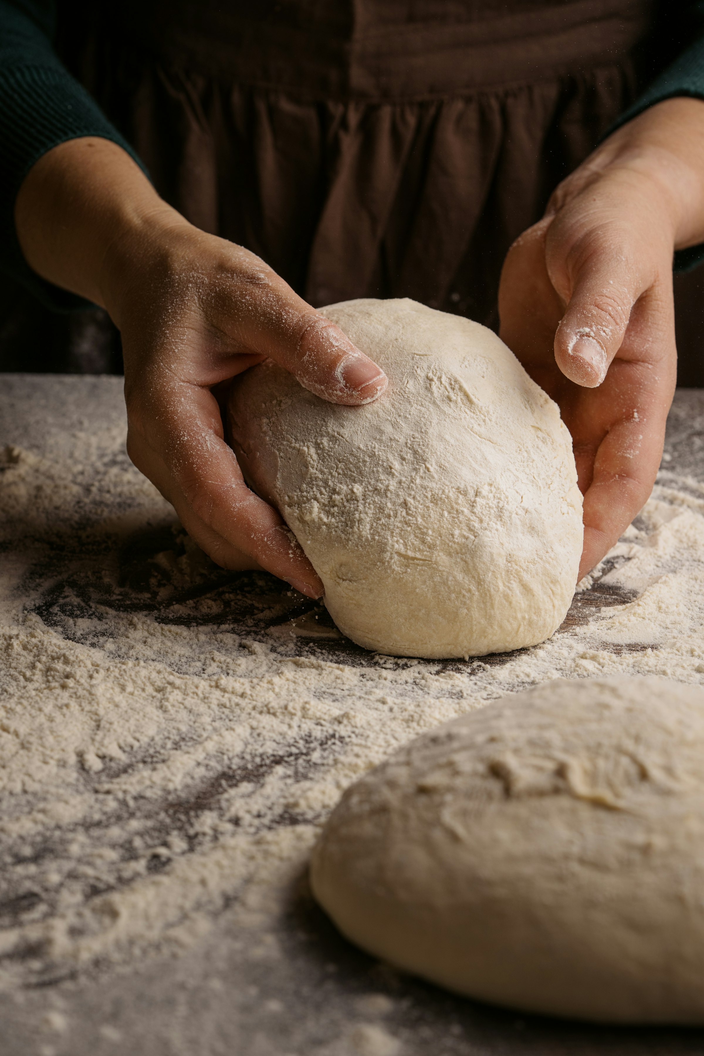 Hands shaping fresh dough